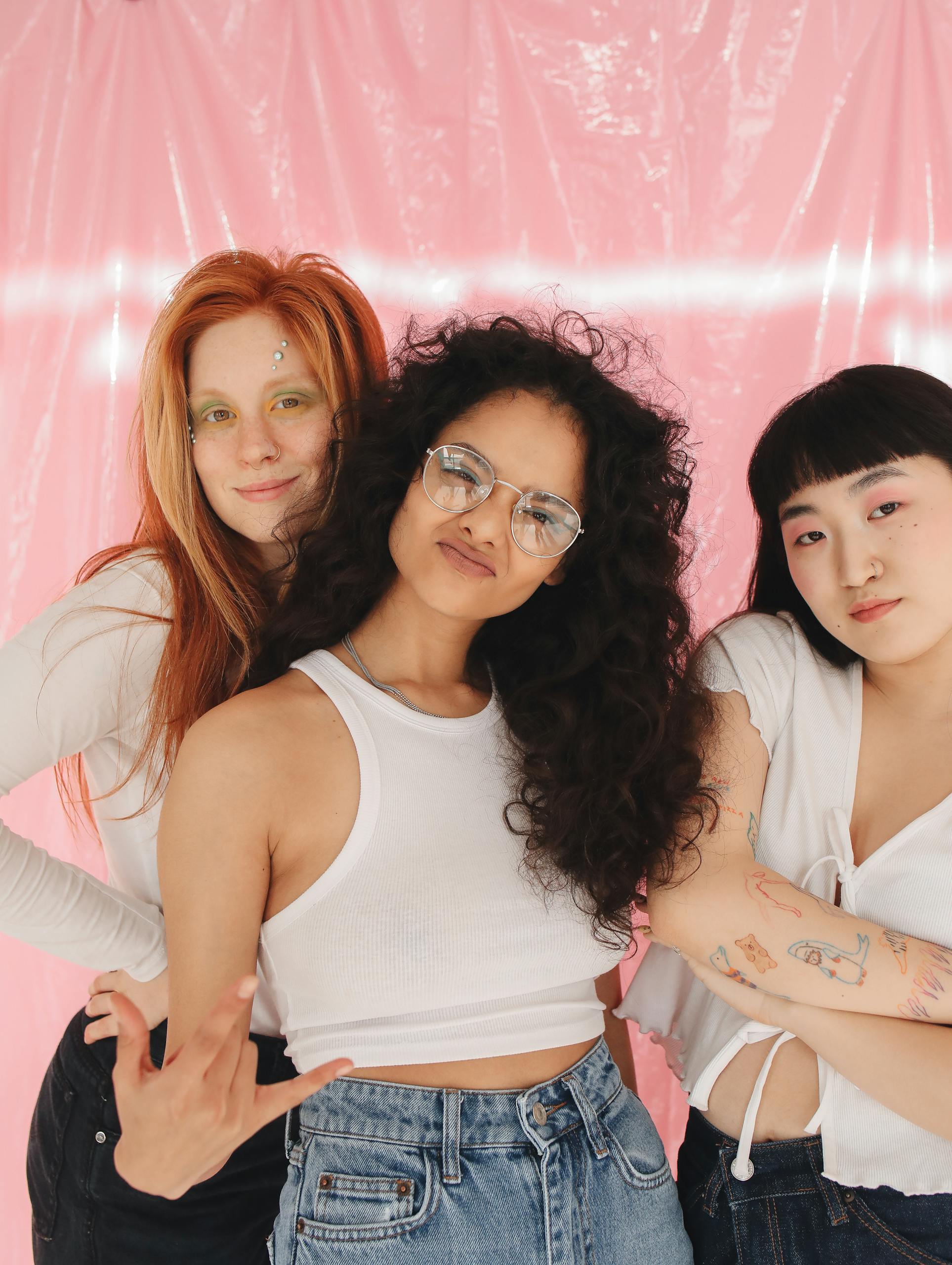 A Group of Young Girls Smiling while Wearing White Tops