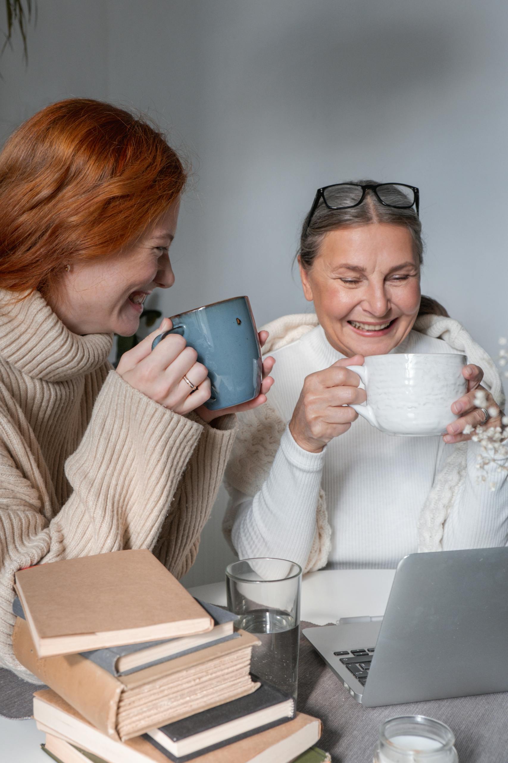 Woman in White Sweater Holding Blue Ceramic Mug